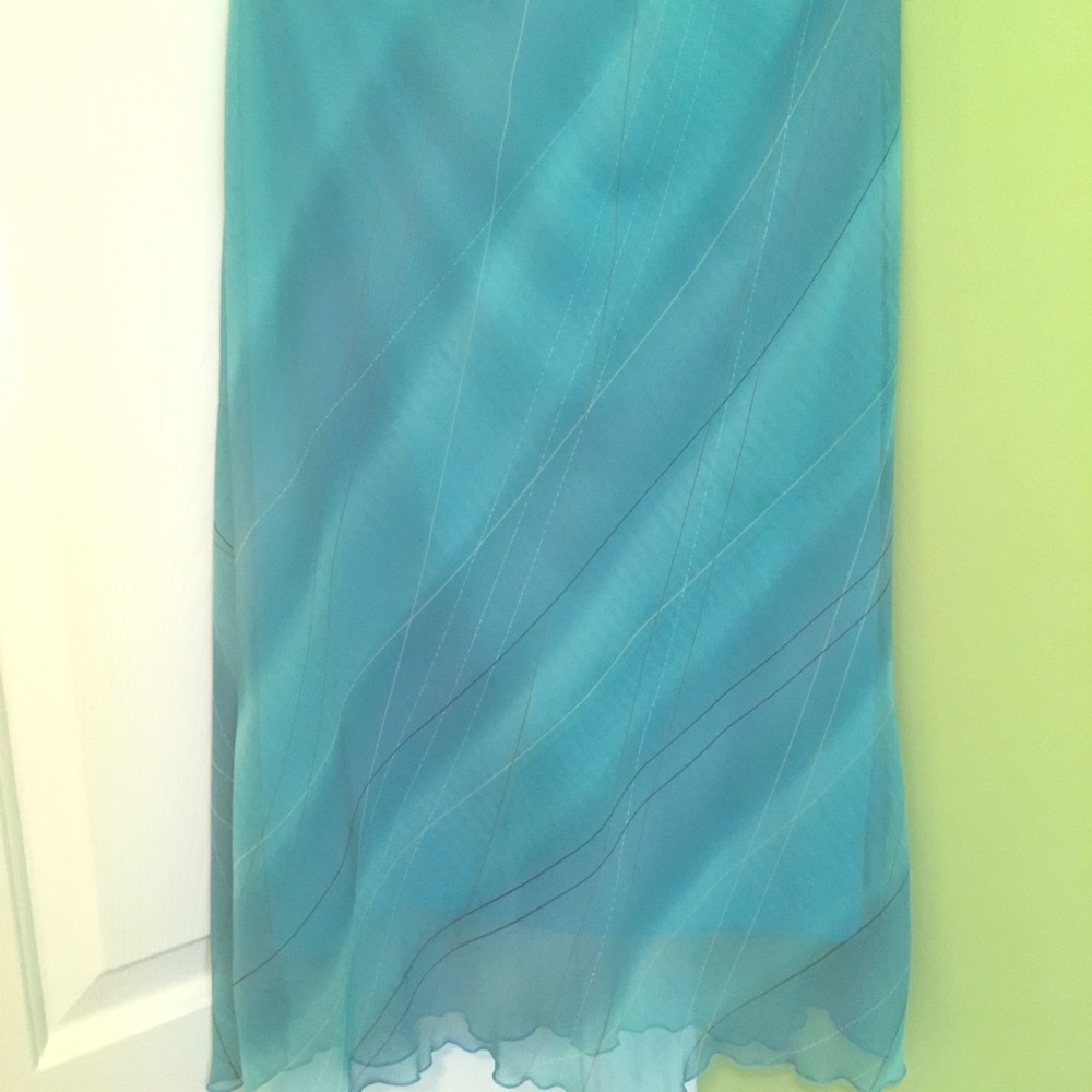 A teal skirt that goes just below knees